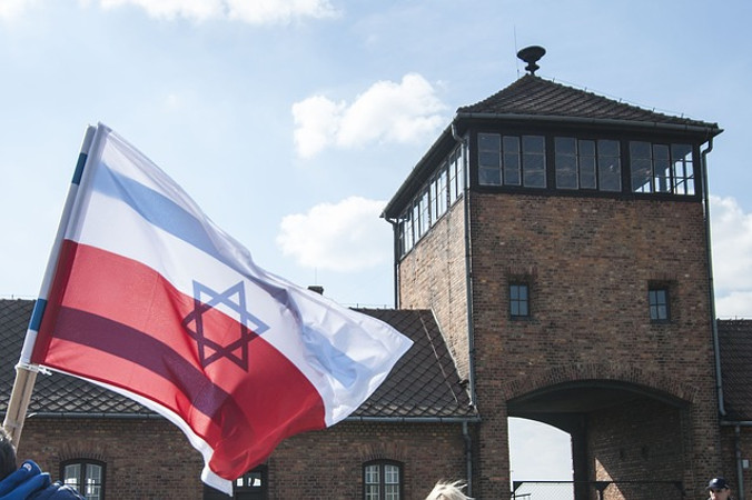 Flagi polska i izraelska w byłym niemieckim nazistowskim obozie Auschwitz-Birkenau (whoismargot / <a href="https://pixabay.com/pl/auschwitz-flaga-polska-2849179/">Pixabay</a>)