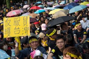 Protestujący trzyma transparent podczas protestu, w którym wzięło udział ponad 200 000 osób sprzeciwiających się kontrowersyjnej umowie o wymianie handlowej z Chinami, Tajpej, Tajwan, 30.03.2014 r. (Lam Yik Fei / Getty Images)