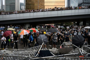 Protestujący stoją przy barykadach podczas wiecu przeciwko ustawie ekstradycyjnej na zewnątrz budynku Rady Legislacyjnej, Hongkong, 12.06.2019 r. (VERNON YUEN/PAP/EPA)