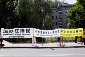 Praktykujący Falun Dafa trzymają transparenty przed Kancelarią Sejmu RP podczas cichego apelu w przededniu 20. rocznicy rozpoczęcia prześladowań Falun Gong przez chiński reżim, Warszawa, 18.07.2019 r. (Karolina Olejniczak / The Epoch Times)