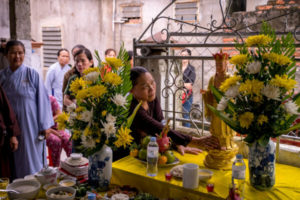 Członkowie rodziny i sąsiedzi Pham Thi Tra My, uważanej za jedną z 39 ofiar znalezionych w ciężarówce z kontenerem-chłodnią w Wielkiej Brytanii, biorą udział w ceremonii modlitewnej z mnichami buddyjskimi przed prowizoryczną świątynią wykonaną dla Pham Thi Tra My w jej domu, prowincja Hà Tĩnh, Wietnam, 28.10.2019 r. (Linh Pham / Getty Images)