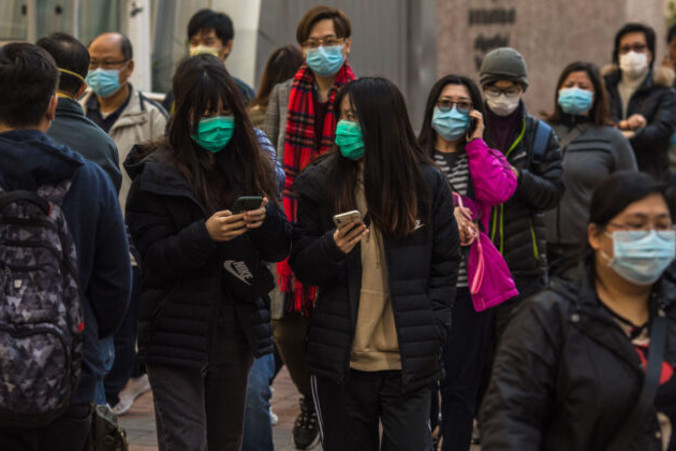Przechodnie chodzą w maskach na ulicy w Hongkongu, 30.01.2020 r. (Dale De La Rey/AFP via Getty Images)