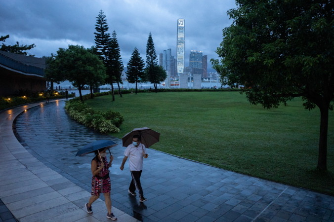 Przechodnie spacerują po parku podczas deszczu przyniesionego przez tajfun Higos, Hongkong, 18.08.2020 r. (JEROME FAVRE/PAP/EPA)