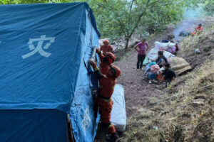 Strażacy rozstawili tymczasowe namioty dla osób wysiedlonych na skutek nocnego trzęsienia ziemi w powiecie Yangbi, prefektura Dali w południowo-zachodniej prowincji Yunnan, Chiny, 22.05.2021 r. (AFP via Getty Images)