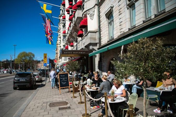 Goście restauracji w Sztokholmie jedzą lunch, Szwecja, 22.04.2020 r. (Jonathan Nackstrand/AFP via Getty Images)