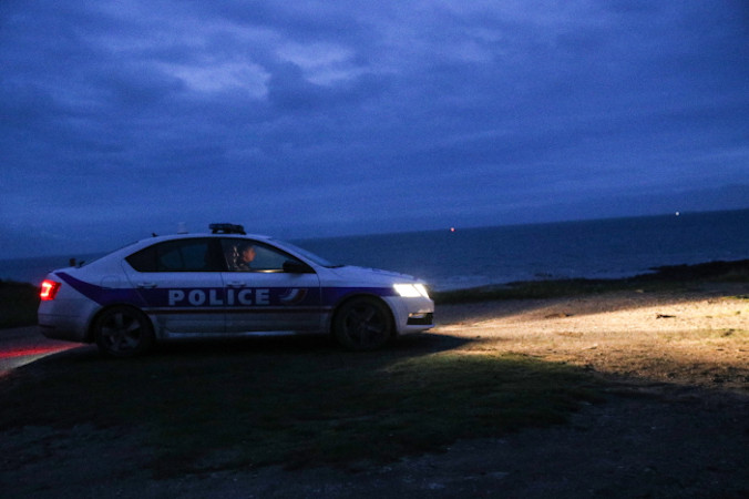Samochód policyjny stoi na straży na plaży w pobliżu Wimereux, Francja, 25.11.2021 r. (Mohammed Badra/PAP/EPA)