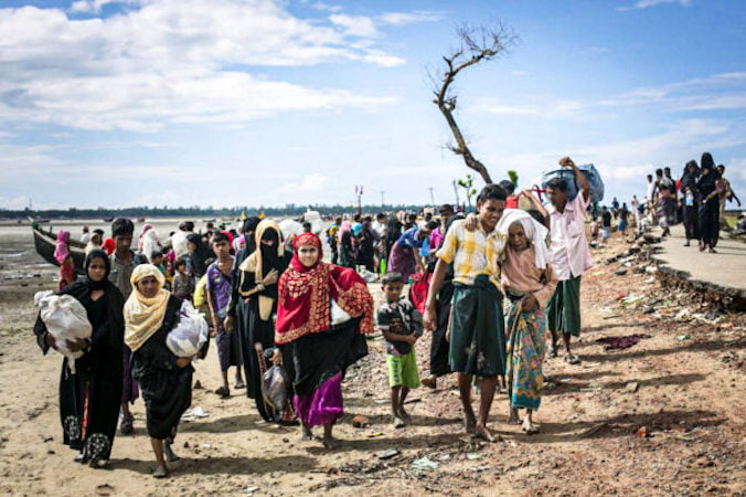 Uchodźcy z ludu Rohingja przemierzają plażę po przybyciu łodzią do Shah Porir Dip, Bangladesz, 14.09.2017 r. (Allison Joyce / Getty Images)