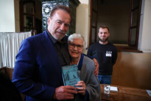Amerykański aktor i polityk Arnold Schwarzenegger (po lewej) oraz ocalona z Auschwitz była więźniarka Lidia Maksymowicz podczas spotkania w Oświęcimiu, 28.09.2022 r. (Łukasz Gągulski / PAP)