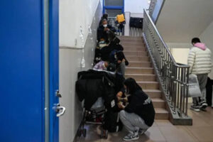 Dzieci otrzymują kroplówkę na schodach w szpitalu dziecięcym w Pekinie, 23.11.2023 r. (Jade Gao /AFP via Getty Images)